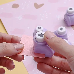 Creative purple manual paper punch for DIY crafts and decorative scrapbooking patterns