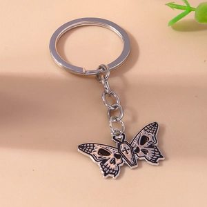 Gothic butterfly skull keychain with black enamel details and coffin shaped body pendant
