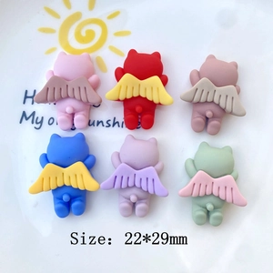 Detail view of colorful 22x29mm winged bear resin charms for DIY phone cases and crafts