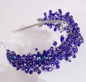 Detailed close-up of handmade bridal headband with deep blue crystal beads and silver wire