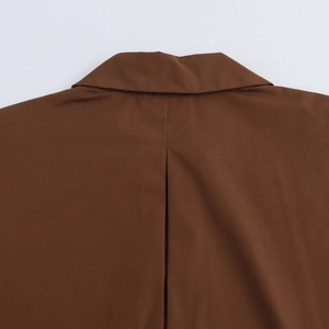 Detail view of a brown poplin shirt featuring a vertical box pleat on the back yoke