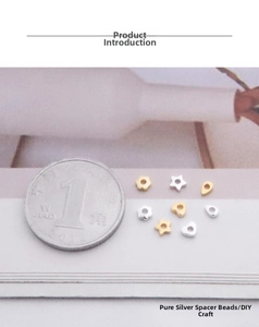 Macro detail of S925 sterling silver heart and star spacer beads for jewelry DIY