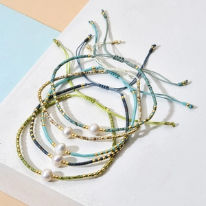 Handmade bohemian beaded bracelet set with white pearls and adjustable woven ropes