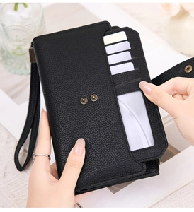Detail of black lychee grain PU leather long wallet with multiple card slots and ID window