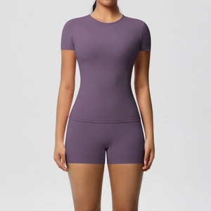 Close-up of seamless dark purple yoga set featuring slim fit t-shirt and high stretch shorts