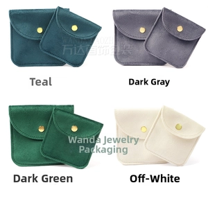 Macro detail of velvet jewelry bags in four colors with gold snap buttons and soft texture