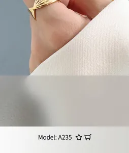 Detailed close-up of 18K gold plated twisted rope ring showing woven texture on finger
