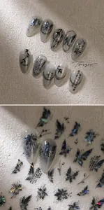 Detailed view of long stiletto press-on nails with butterfly and bamboo calligraphy art