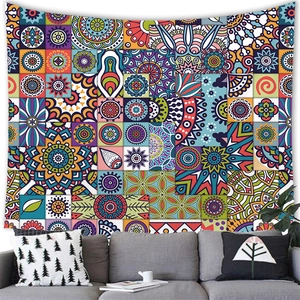 Detailed view of bohemian mandala tapestry hanging over a cozy grey sofa in a living room