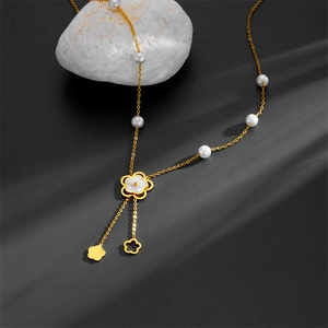 Elegant gold camellia pendant necklace with white mother-of-pearl and pearl accents