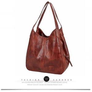 Detail of vintage brown leather patchwork tote showing stitching and logo patch