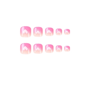 Faux ongles d'orteils dégradés roses avec motifs de cœur blanc et finition lisse