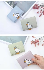 Detail of cute duck cartoon mini wallet in pastel colors with high quality PU leather texture
