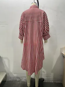 Detail of red and white striped shirt featuring horizontal contrast yoke and irregular hem