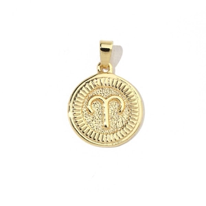 Detailed view of 18k gold plated Aries zodiac pendant with sunburst texture