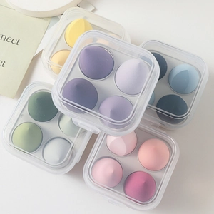 Detail of 4-pack macaron makeup sponge set in transparent square portable storage box