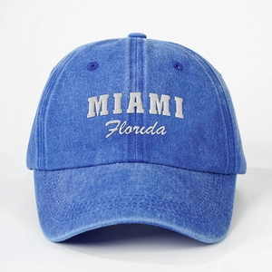 Close-up of white MIAMI Florida embroidery on blue washed denim baseball cap