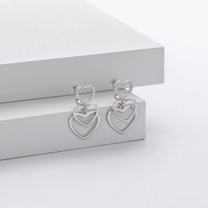 S925 sterling silver triple heart drop earrings with sparkling cubic zirconia on white stone