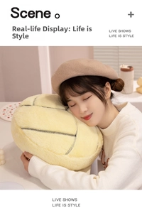 Close-up of yellow plush volleyball pillow with soft texture and black stitching details