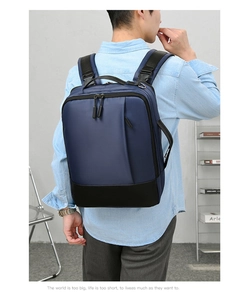 Detail of dark blue business laptop backpack showing side handle and minimalist dual-tone design