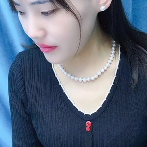 Classic white freshwater pearl necklace and earring jewelry set worn by a female model