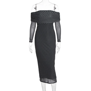 Detail of elegant black mesh dress with white polka dots and pleated off-shoulder neckline