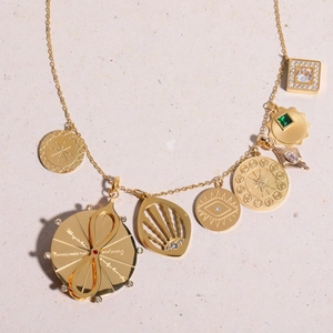 Gold plated necklace with tarot eye and zodiac charms featuring clear and green zircon stones