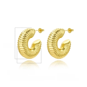Detail view of hollow 18k gold plated ribbed C-shape earrings with mirror finish