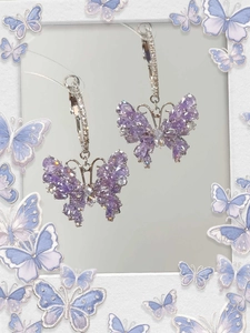 Detail of lavender butterfly pendant earrings with sparkling zircons and silver base