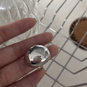 Macro shot of high-polished silver dome ring with thick arched profile and mirror finish