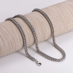 Polished silver foxtail chain necklace for men shown on a textured display cylinder