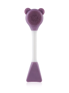Close-up of double-headed silicone facial brush with bear-shaped bristles and mask spatula