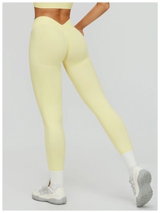 Detail view of bright yellow high waist seamless yoga pants with V-shaped waistband and scrunch butt