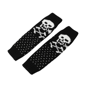 Close-up of black knitted fingerless gloves with white skull pattern and dot details