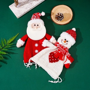 Detail of knitted Christmas gift bags with 3D Santa and Snowman doll designs