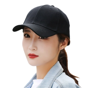 Detailed side view of a black cotton twill baseball cap on a model with curved brim