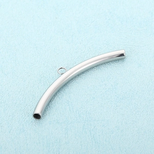 Macro shot of silver stainless steel curved tube connector with ring for DIY bracelet