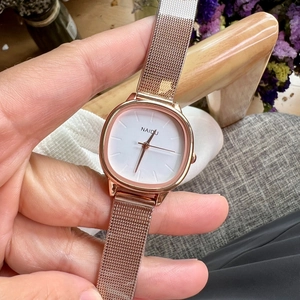 Close-up of a stylish square rose gold mesh watch with a minimalist white dial by Naidu