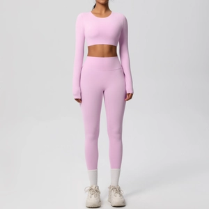 Close-up of pink long sleeve crop top and high waist leggings fitness set