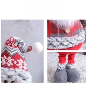 Detail showing knitted snowflake hat and grey plaid fabric on a Christmas gnome doll