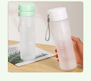 Detail of portable frosted plastic sports bottles with carrying ropes and tea filters