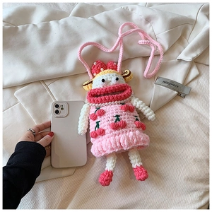 Detailed view of pink handmade crochet phone bag with cherry patterns and pearl strap