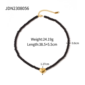 Detail view of black beaded heart necklace showing 24g weight and 38cm length specs