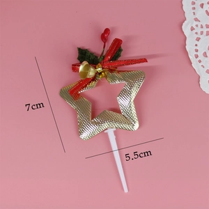 Detail of Christmas tree star cake topper with red bow, gold bell and holly berries