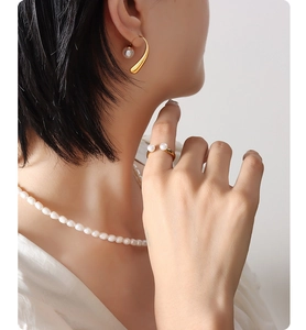 Detail of French vintage 18K gold plated pearl earring, ring, and necklace set for women