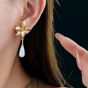 14K gold plated flower earrings with pearl drop pendant shown on model