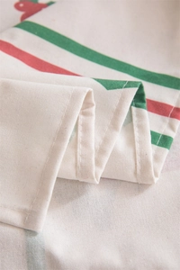 Close-up of linen fabric texture with red and green stripes and delicate stitching details