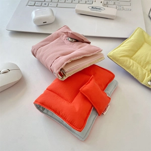 Detail of colorful quilted puffer binder covers with metal snap closure and loose-leaf ring