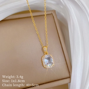 Detail view of gold titanium necklace with zircon pendant including size and weight specs
