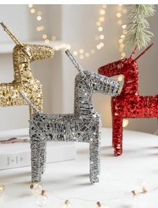 Close-up of glittery metal reindeer Christmas ornaments in gold, silver and red finish